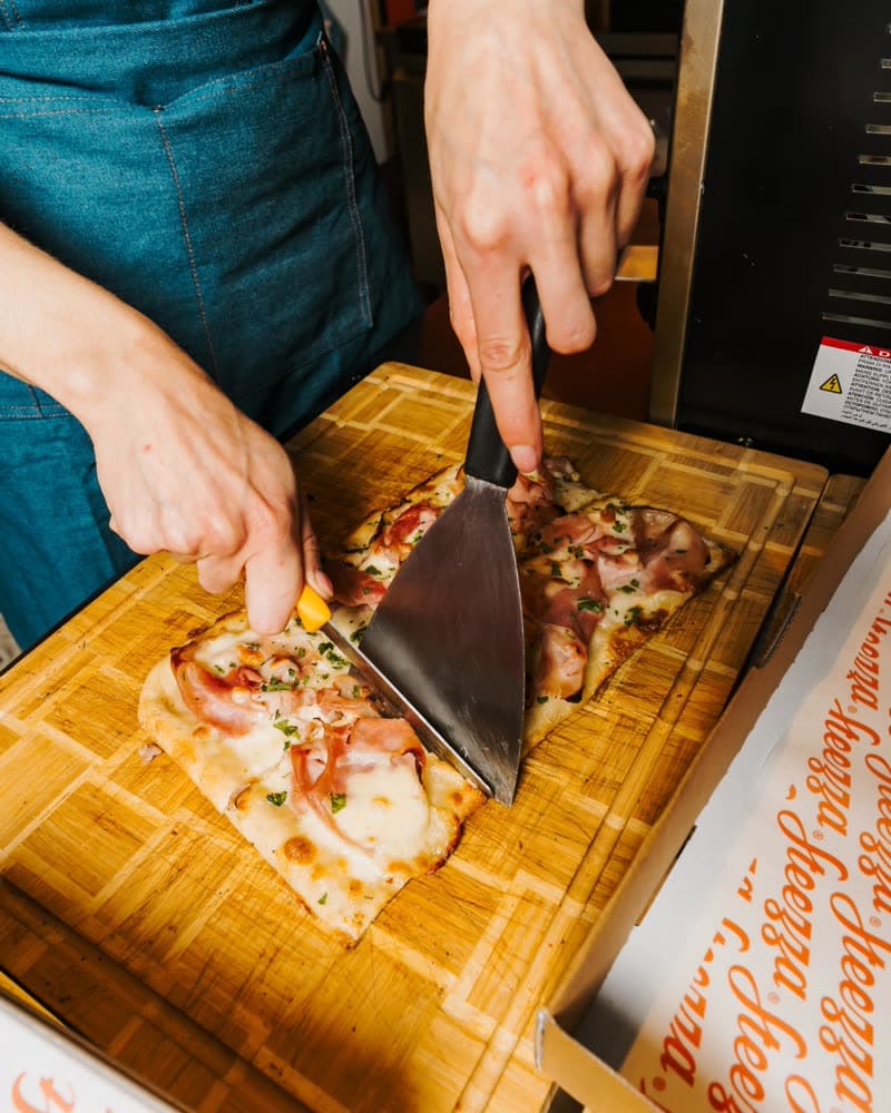 Cutting a Roman-style slice on a wooden board